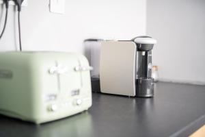 a counter top with a coffee maker and a toaster at Dryburgh Apartments No2 in Inverness