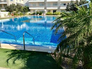 a large swimming pool in front of a building at Mythical Sands Resort - Good Vibes Apartment in Paralimni