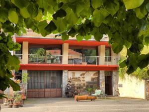 a house with a balcony on the front of it at LOFT nelle Valli in Pessinetto