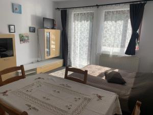 a bedroom with two beds and a window at Hygge House in Buşteni