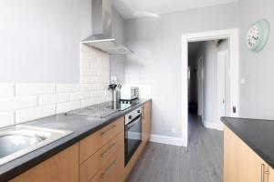 a kitchen with a sink and a counter top at Dryburgh Apartments No2 in Inverness