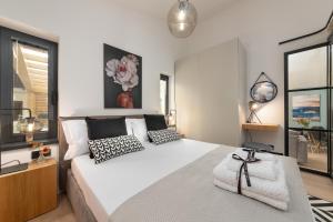a bedroom with a large white bed with black and white pillows at Villa Villetta in Novigrad Istria