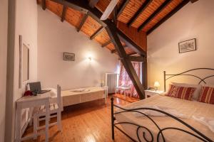 A bed or beds in a room at Archontiko Petrettini Boutique Hotel