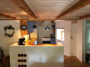 a kitchen with wooden ceilings and a counter top at Gæstehus Nyord in Nyord