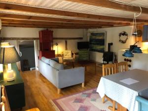 a living room with a couch and a table at Gæstehus Nyord in Nyord +5 photos