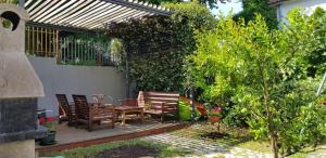 a patio with chairs and a table and a fence at Apartment FINI in Tivat