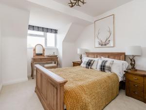 a bedroom with a bed and two night stands at Pike and Eel Hotel and Marina in Needingworth