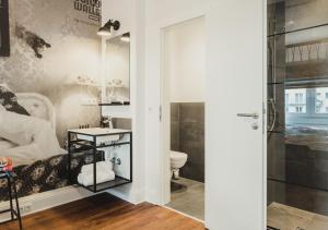 a bathroom with a shower and a toilet and a sink at Pyjama Park St. Pauli in Hamburg