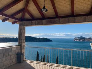 a balcony with a view of the ocean at Apartment and room Sveti Jakov in Dubrovnik