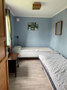 a bedroom with a bed and a desk in a room at Ekhaga, Hultåkra in Mariannelund