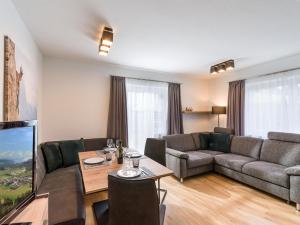 a living room with a couch and a table at Appartement Ortner in Westendorf