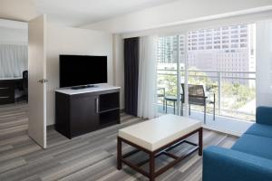 a living room with a tv and a couch and a table at Holiday Inn Express - Downtown San Diego by IHG in San Diego