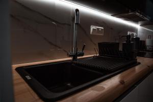 a kitchen sink with a faucet on a counter at COSea Living: SeaSide Luxury Suite in Harbour 107A in Paphos City +29 photos