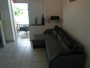 a living room with a couch and a table at Apartments Luna in Žuljana