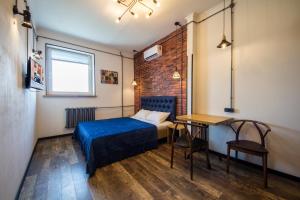 a bedroom with a bed and a desk and a table at DayFlat Apartments Khreschatyk in Kyiv +235 photos