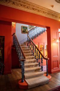 a staircase in a home with red walls at The Portobello Hotel in London