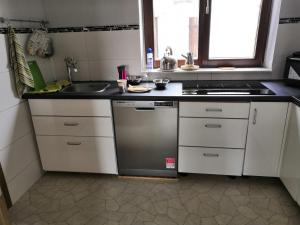 a kitchen with a sink and a stove at Zu Hause auf Zeit bei Marion in Bobbau