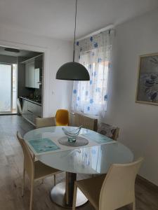 a dining room with a glass table and chairs at Apartment Tina in Split