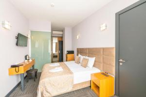 A bed or beds in a room at Taksim Hotel V Plus