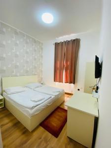 a bedroom with a bed and a television in it at Easy Star Hotel in Budapest