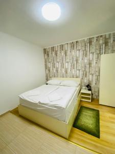 a bedroom with a white bed and a chalkboard at Easy Star Hotel in Budapest