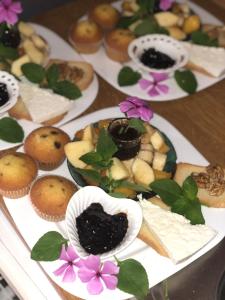 a table topped with plates of pastries and desserts at Vila Isufaj in Vlorë +8 photos