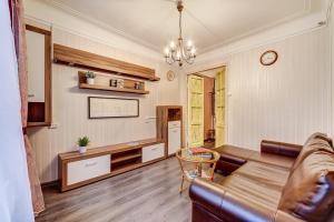a living room with a couch and a table at Welcome Home Apartments Liteyniy 10 in Saint Petersburg