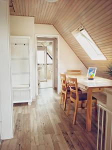 a kitchen and dining room with a table and chairs at Ferienwohnung Prange Cuxhaven in Cuxhaven