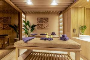 a room with two beds with purple towels on them at Kaya Palazzo Resort & Residences Le Chic Bodrum in Bodrum City
