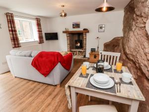 a living room with a table and a couch at The Old Mill Bake House in Ross on Wye