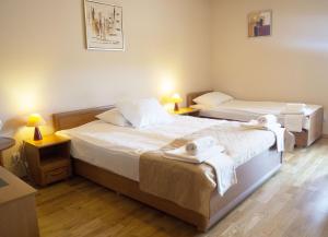 two beds in a room with towels on them at Zajazd Beskidy in Żywiec