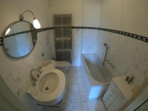 La salle de bains est pourvue de toilettes, d'un lavabo et d'une baignoire. dans l'établissement Villa Reginella, à Varenna
