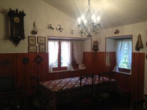 a bedroom with a bed and a clock and windows at Esclusivo chalet immerso nel verde in Filettino Graziani