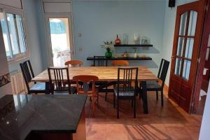 een eetkamer met een houten tafel en stoelen bij Casa céntrica en Platja d'Aro, a 5min de la playa in Platja  d'Aro