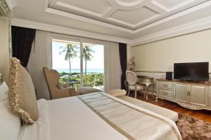 a hotel room with a bed and a large window at LK The Empress in Pattaya Central