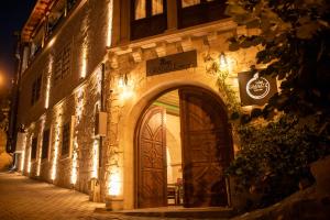 a building with a door on a street at night at Pome Granate Cave Hotel in Nevşehir