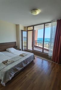 a bedroom with a bed and a view of the ocean at Свети Зосим in Sozopol