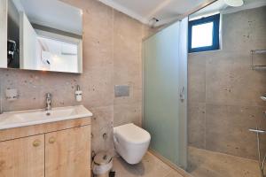 a bathroom with a toilet and a sink and a shower at Happy Kaş Apart in Kaş