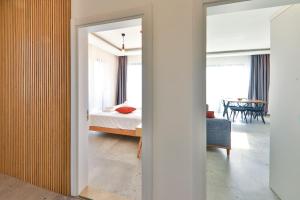 a bedroom with a bed and a room with a mirror at Happy Kaş Apart in Kaş