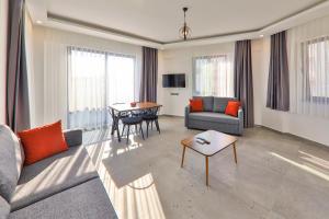 a living room with a couch and a table at Happy Kaş Apart in Kaş
