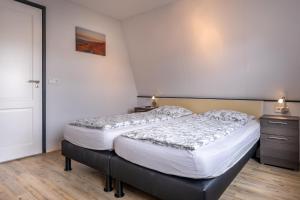 a bedroom with two beds in a room at Vakantiehuis Rehoboth in Domburg