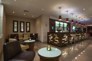 a restaurant with a bar with tables and chairs at Vila Gale Cascais in Cascais