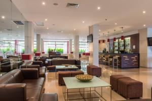 a lobby with couches and tables and a pharmacy at Vila Gale Cascais in Cascais