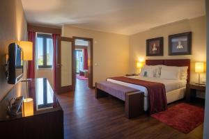 a hotel room with a bed and a television at Vila Gale Cascais in Cascais