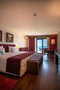 a hotel room with a bed and a view of the ocean at Vila Gale Cascais in Cascais