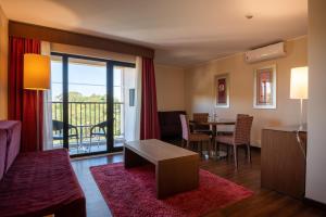 a living room with a couch and a table at Vila Gale Cascais in Cascais