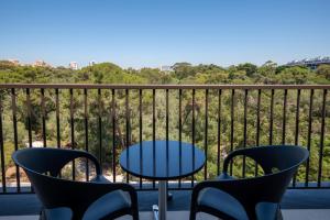 a patio with a table and chairs on a balcony at Vila Gale Cascais in Cascais