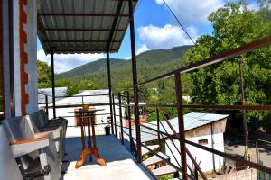 a balcony with a view of the mountains at holiday home in Borjomi