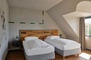 Postel nebo postele na pokoji v ubytování Kröger by Underdog Hotels
