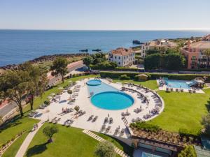 an aerial view of a resort with a swimming pool and the ocean at Vila Gale Cascais in Cascais